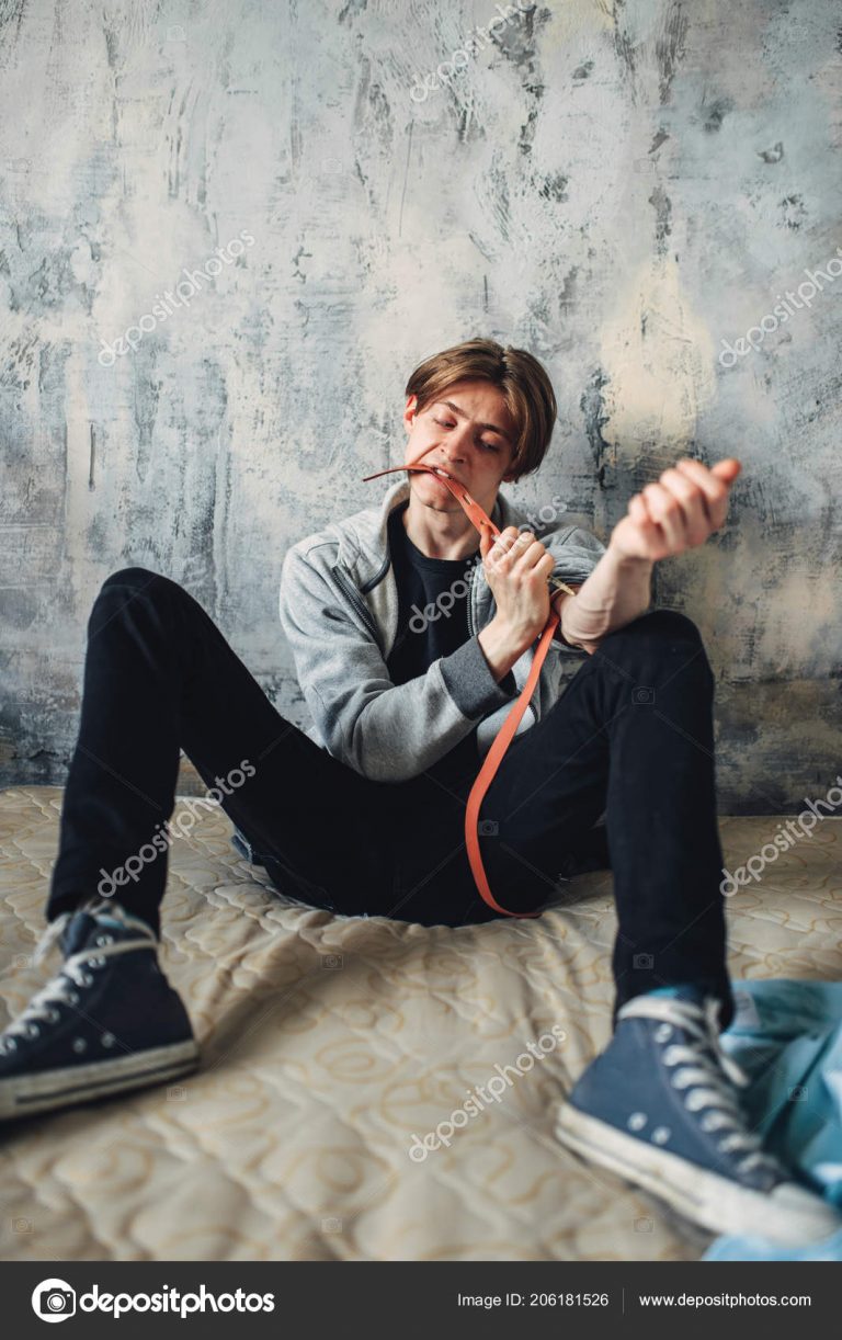 Male druggy with syringe doing an injection dose